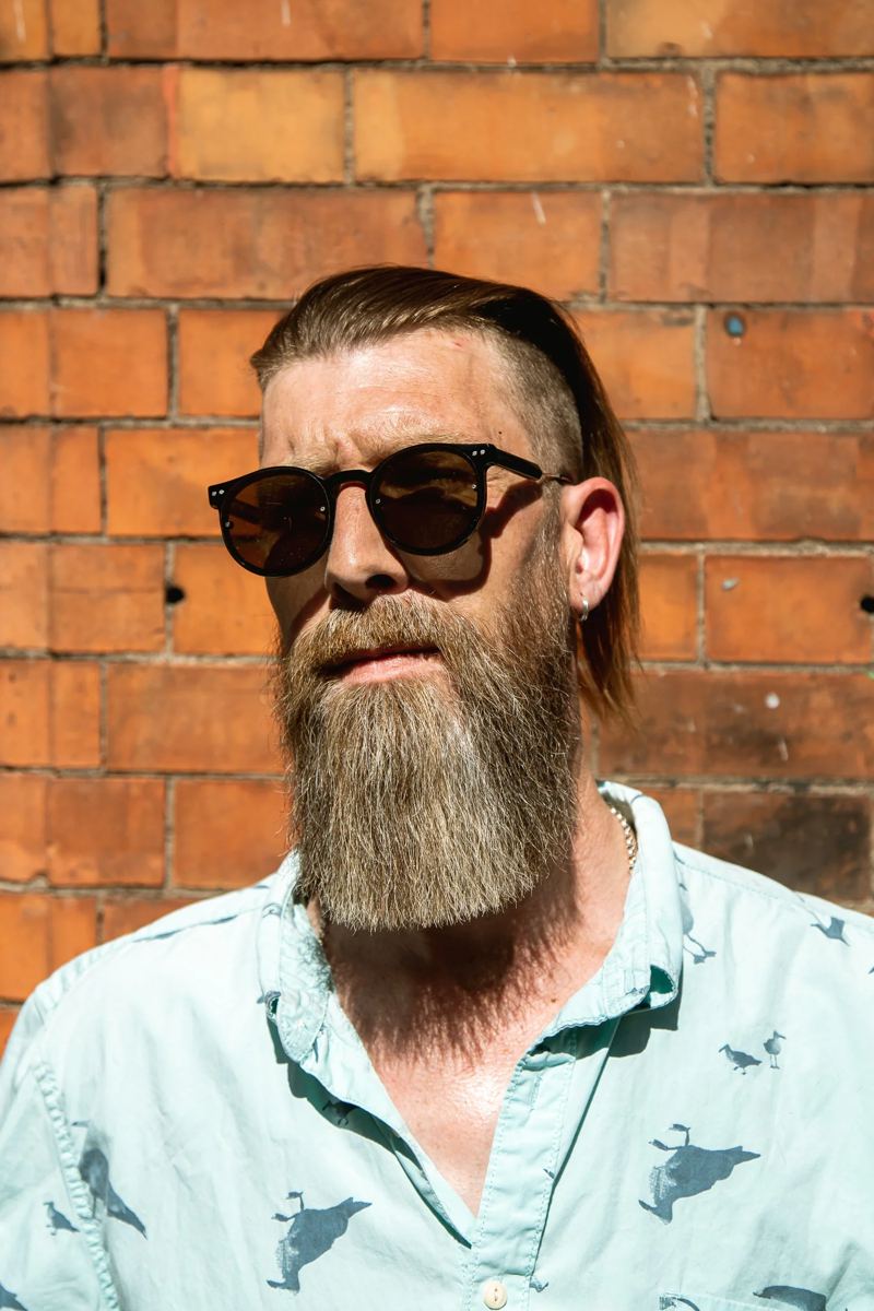 Long swept-back hair with a long full beard